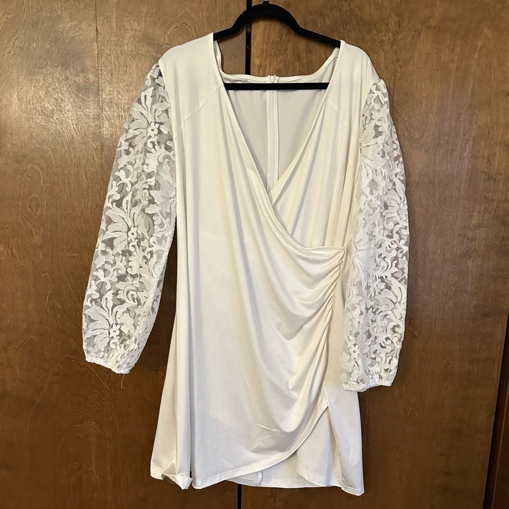 A shorter white dress with laced sleeves. Relaxed and comfortable to wear.